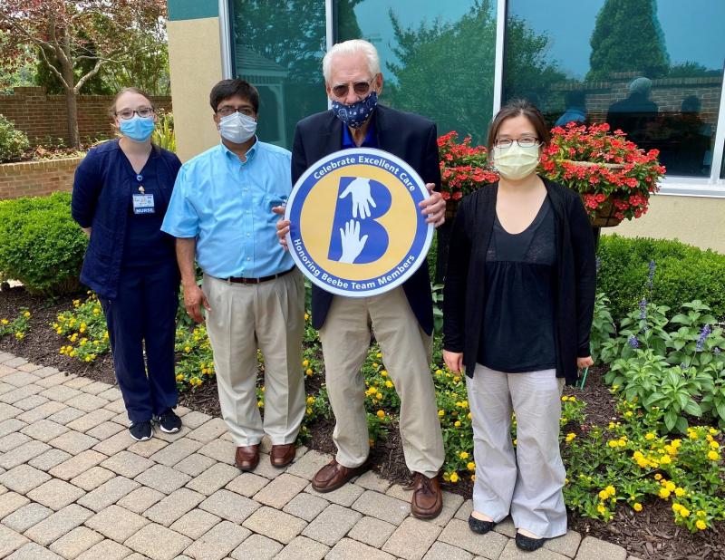 Fred Gibbs gathers with some of Beebe Healthcare’s excellent care providers in the Healing Garden at Tunnell Cancer Center. Shown are (l-r) Nurse Marissa Setzer, Dr. Pramod Vadlamani, Gibbs, and Dr. Jennifer Hung. SUBMITTED PHOTO